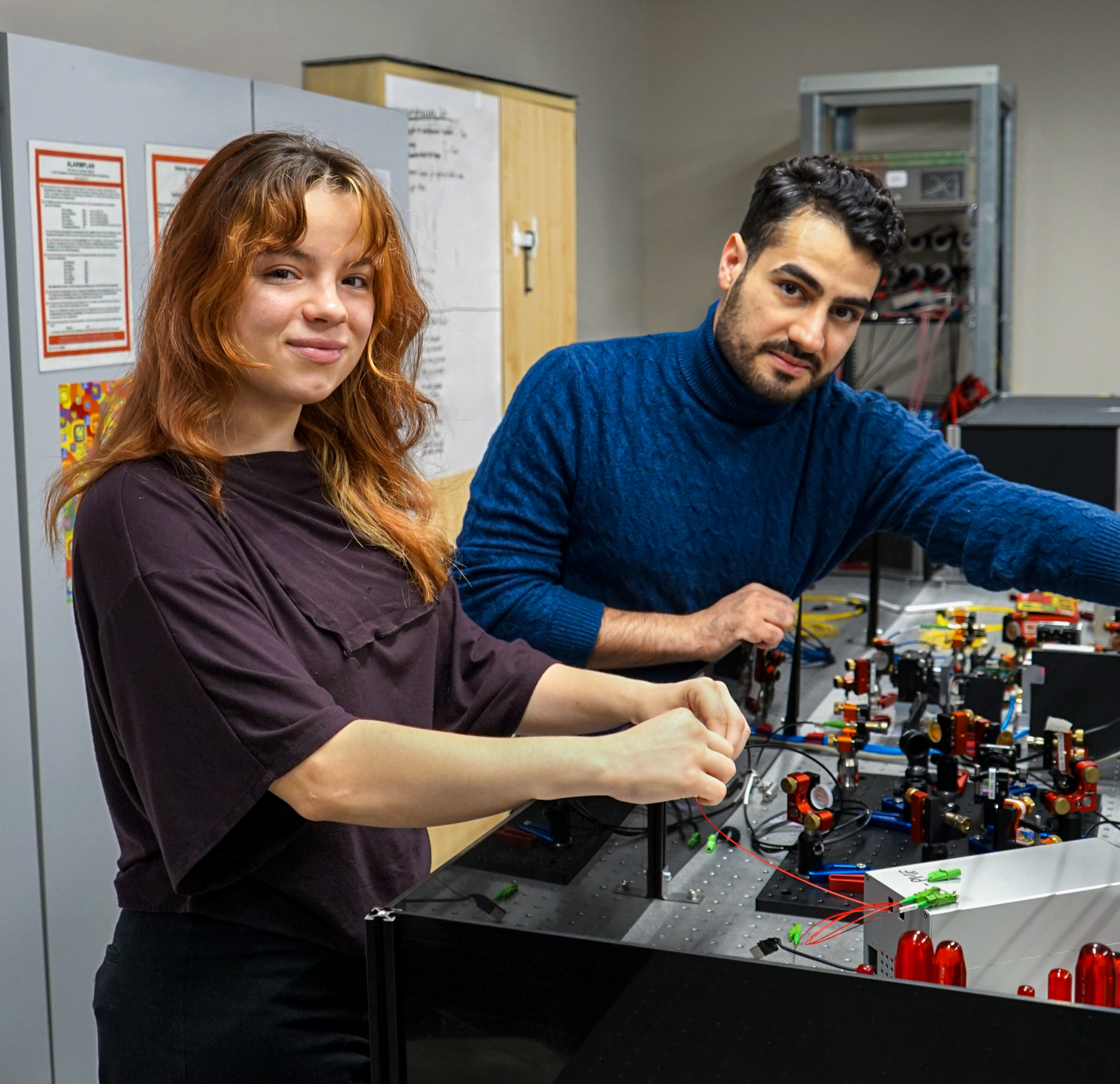 Members of the AQLS team with optical hardware in the laboratory
